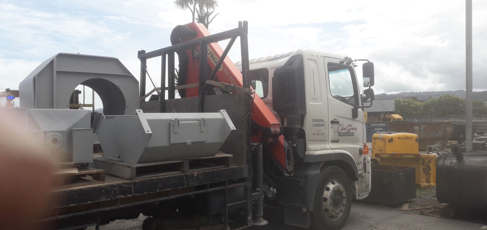 CDT Transport HIAB crane lifting machinery straight off the truck, Wellington